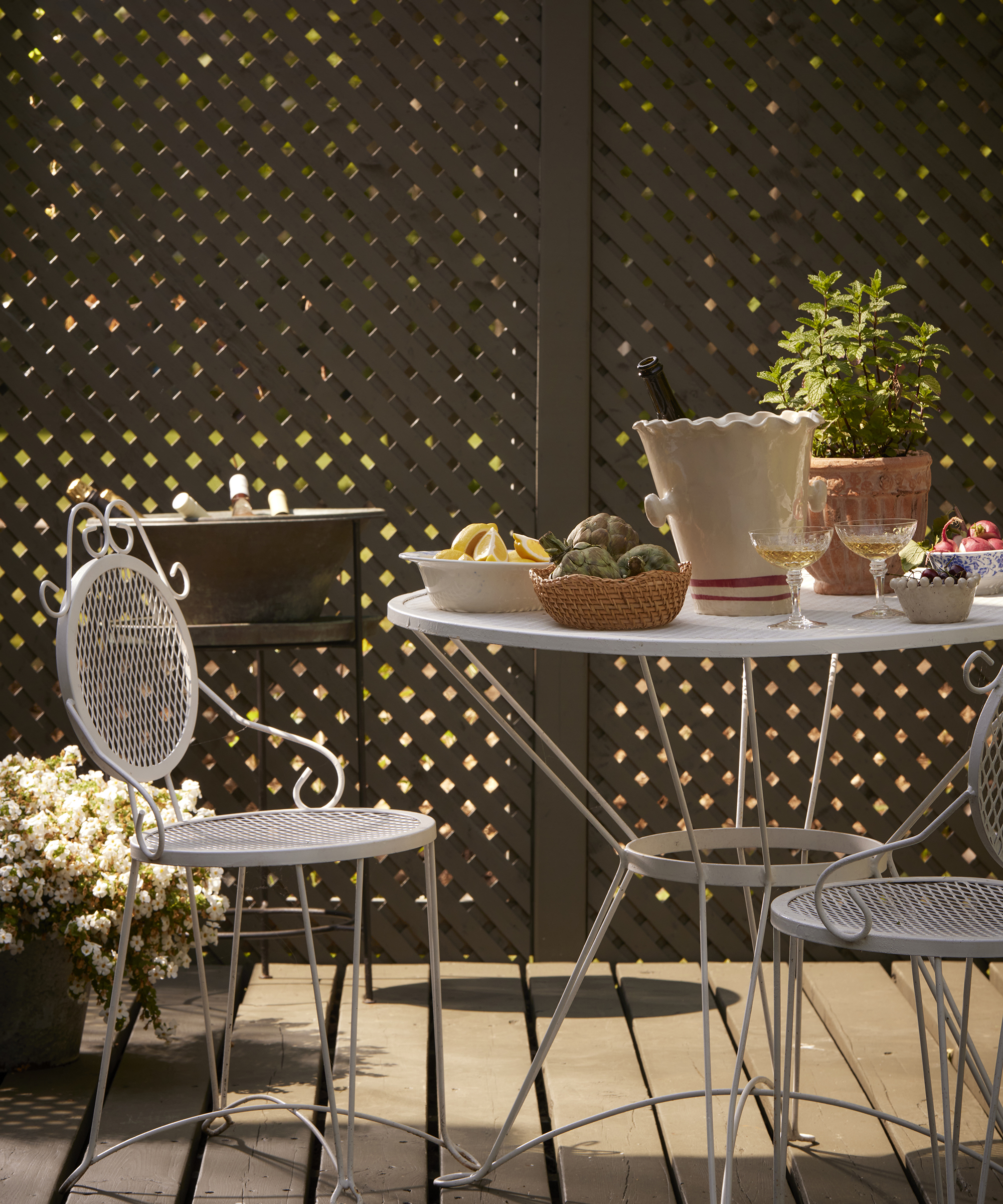 outdoor table area with round table set with food and plants