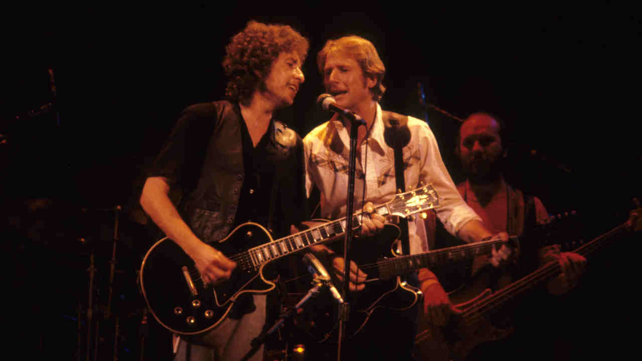 Roger McGuinn performing onstage with Bob Dylan in 1980