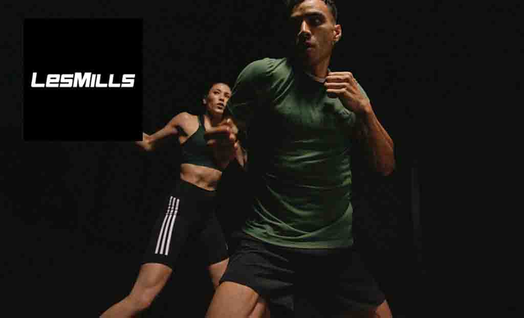 Les Mills logo placed in the top left corner with an image of two people in gym gear in a fighting stance 