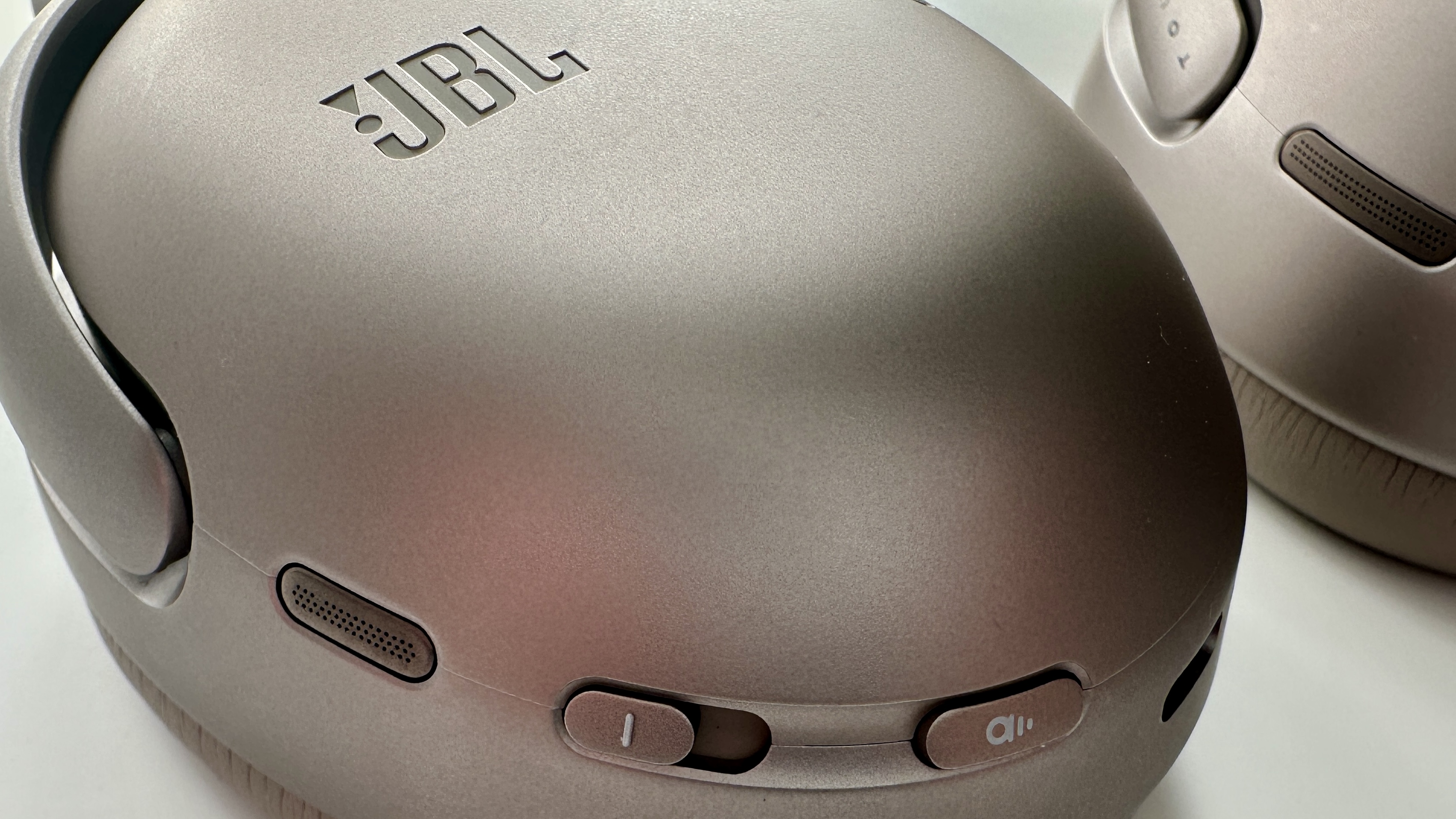 JBL Tour One M3 over-ear headphones earcup showing touch buttons