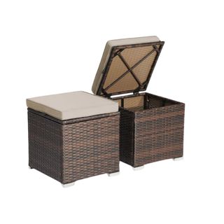 Outdoor rattan storage ottoman for the outdoors with a white cushion on top