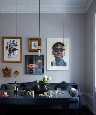 Art wall with hanging lights, expert living room lighting tips from Buster + Punch