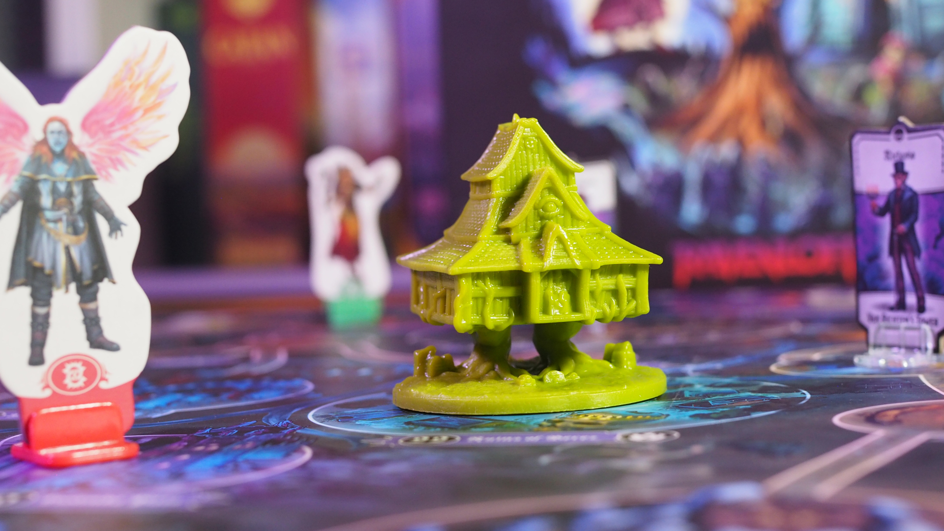 Baba Lysaga's hut model with tokens surrounding it, on the Horrified Ravenloft board