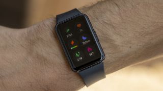 The Samsung Galaxy Fit 3 watch in grey worn on a female wrist