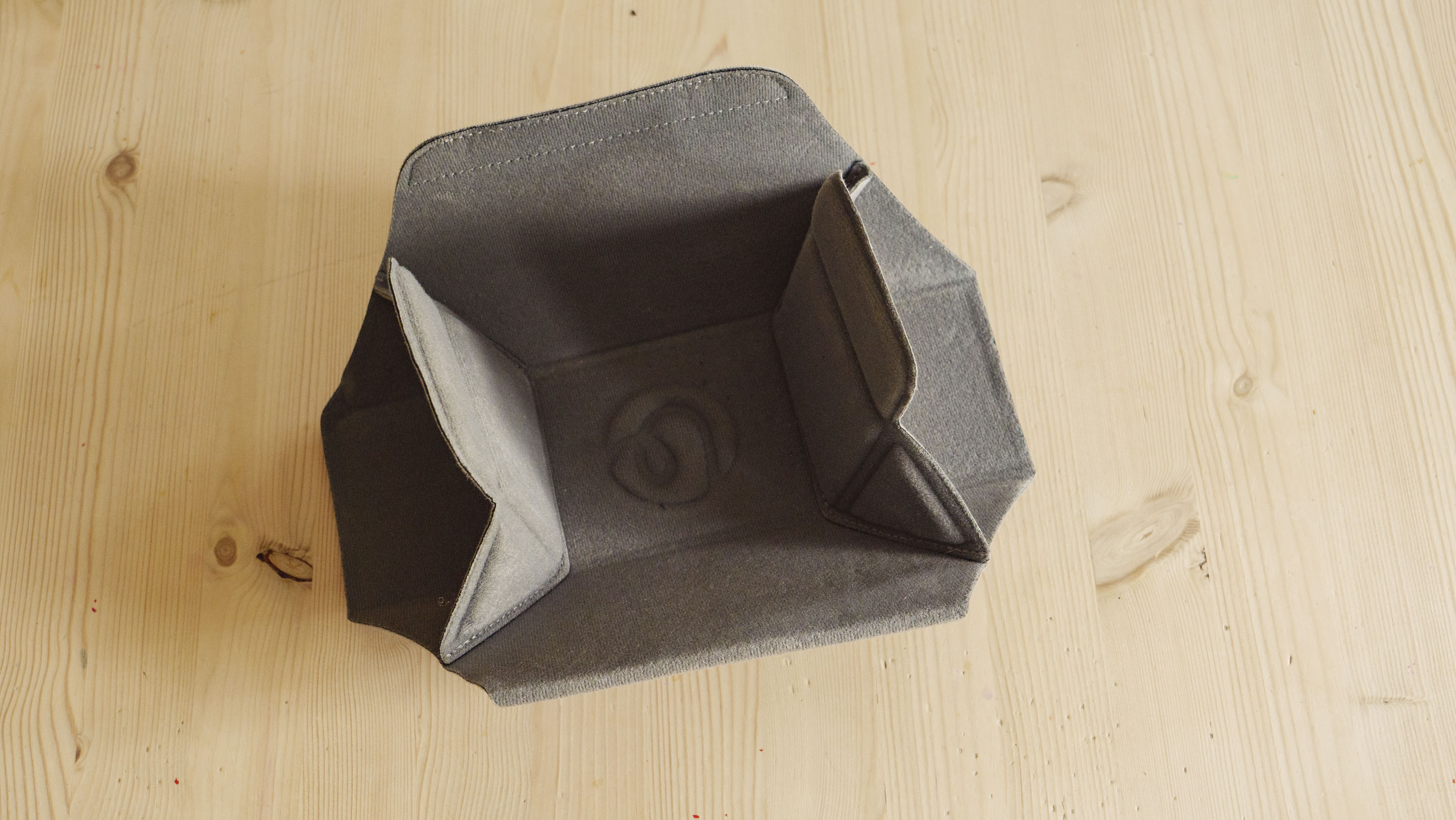 The Ulanzi Camera Sling Bag's padded insert on a wooden table