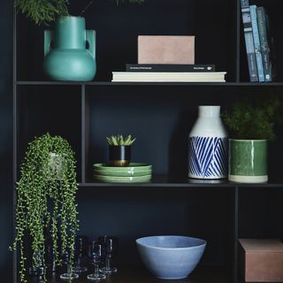 dark blue room with shelf and bowls glasses