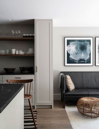 a kitchen living space with grey cabinets