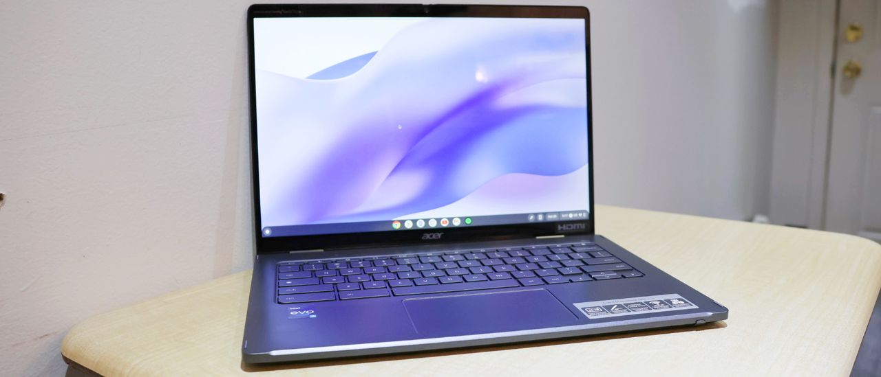 The Acer Chromebook Spin 714 review facing forward on a white desk against a white wall.