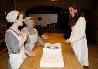 The Duchess of Cambridge chats to actresses Sophie McShera and Lesley Nicol during an official visit to the set of Downton Abbey at Ealing Studios in London