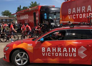 The Bahrain Victorious bus and team vehicles