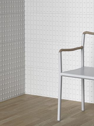 White tiles with dotted relief with white chair by Bouroullec Studio for Artek