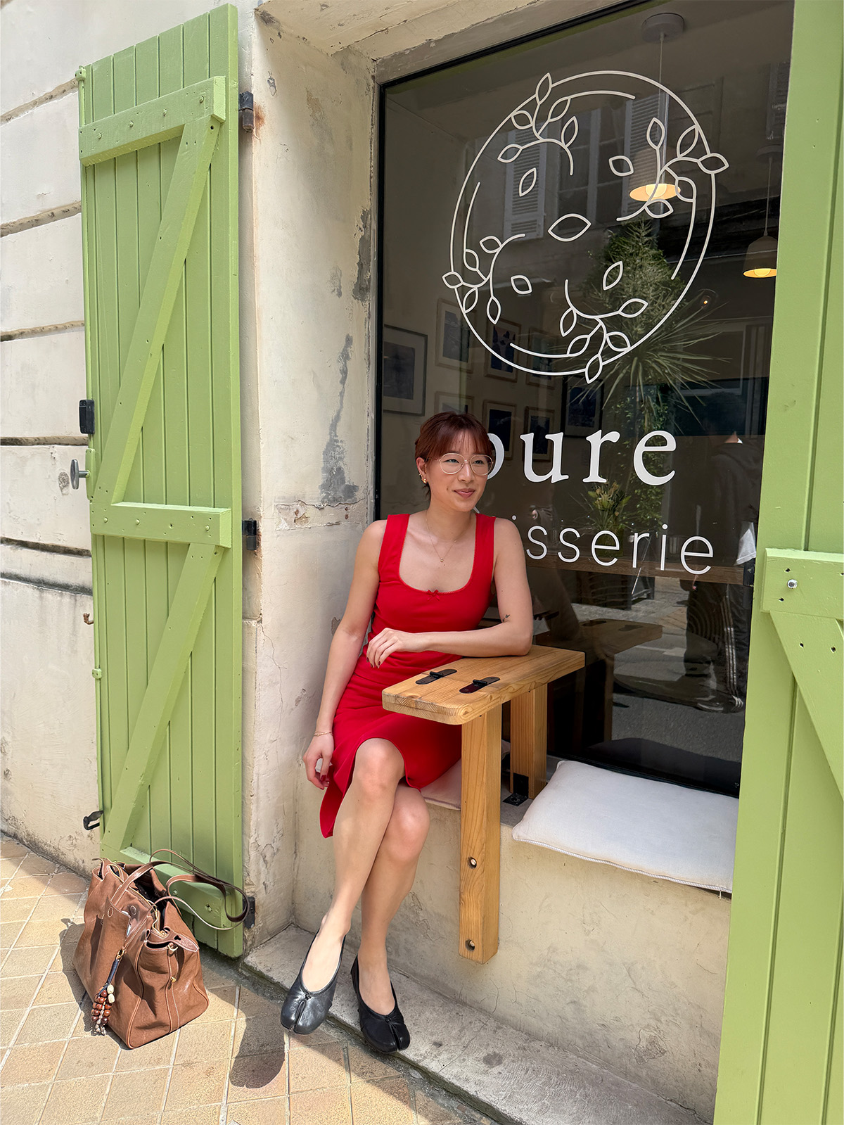 @kristinamichelleang wearing a red two-piece set and ballet flats in Paris.