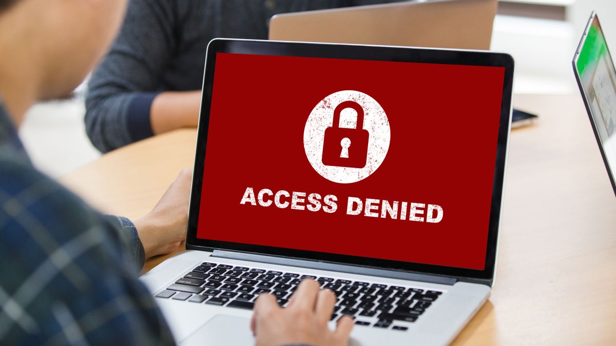 A laptop screen showing &amp;quot;access denied&amp;quot; text on a red background