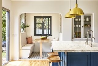 A kitchen with a small seating nook