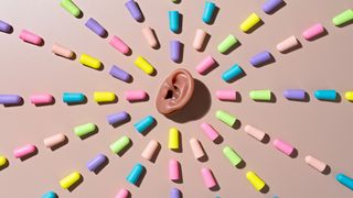 Best earplugs for concerts: An ear with a pattern of foam earplugs surrounding it