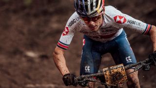 A mud-covered Tom Pidcock rides his mountain bike at the UCI Mountain Bike World Championships 2020 Leogang, Austria