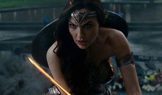 Justice League Wonder Woman stands in attack stance with her sword