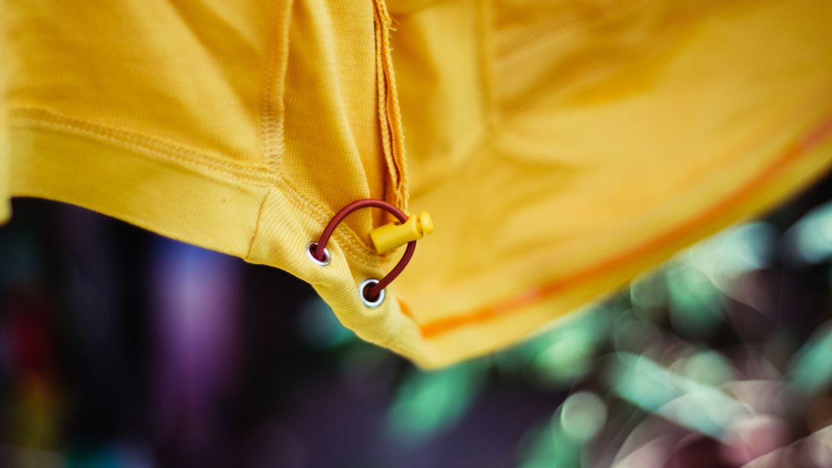 The elasticated hem of a yellow jersey