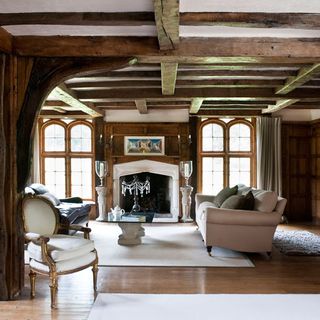 hallway with exposed beams and white sofa