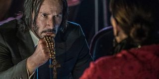 John Wick: Chapter 3 - Parabellum Keanu Reeves holding a cross desperately in front of himself