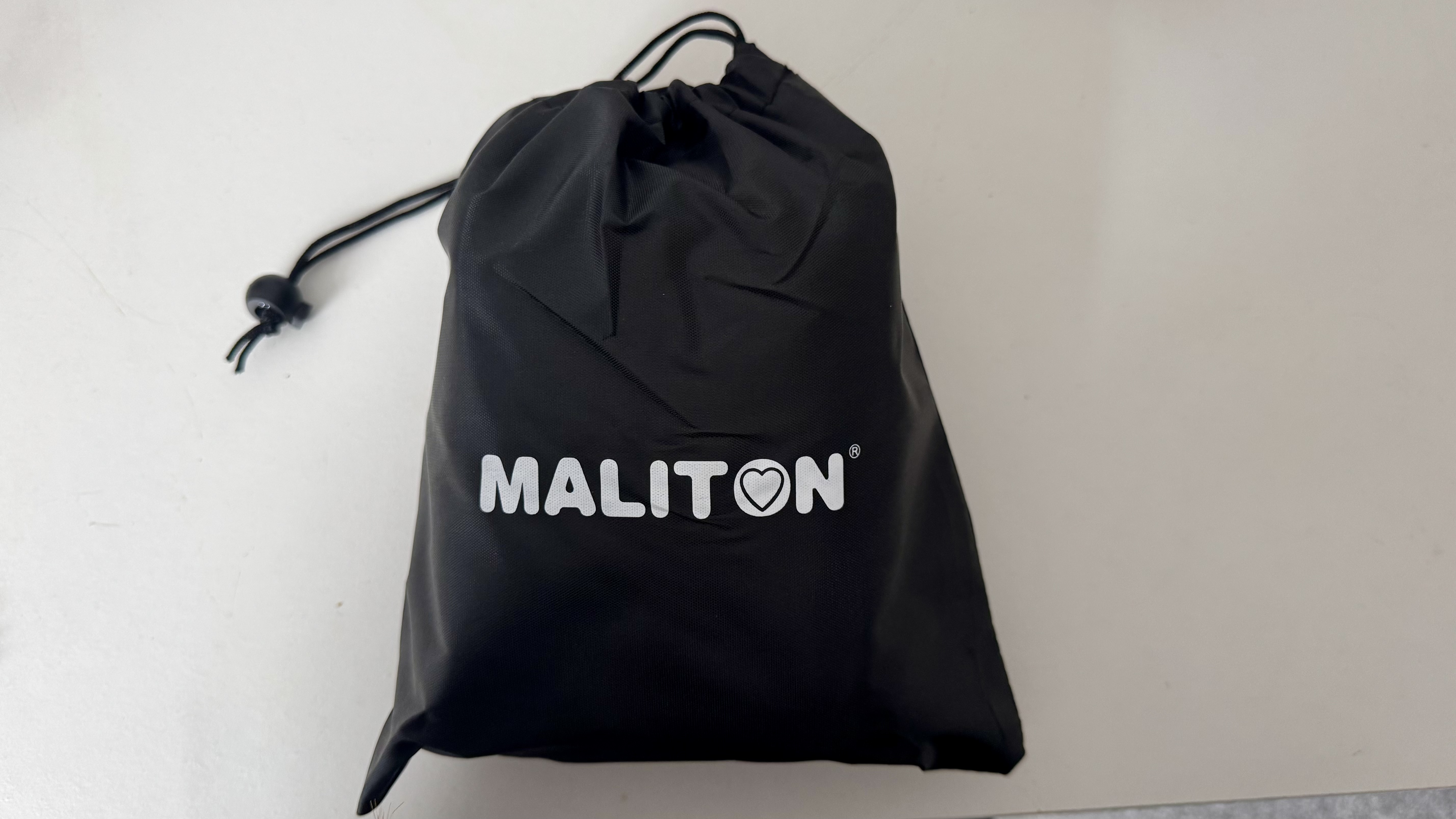 The Maliton inflatable travel pillow packaged and inflated