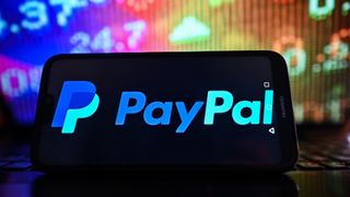 POLAND - 2023/02/01: In this photo illustration, a Paypal logo is displayed on a smartphone with stock market pricing in the background. (Photo Illustration by Omar Marques/SOPA Images/LightRocket via Getty Images)