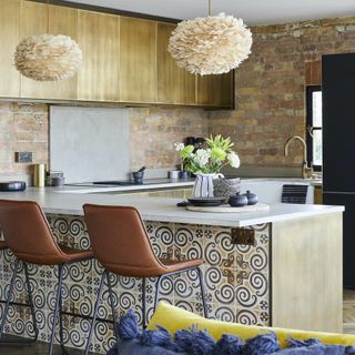 bronze kitchen with vintage tiles, leather stools and feather pendants