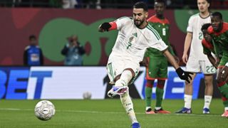 Riyad Mahrez (L) shoots and scores his team's first goal from the penalty spot during the Africa Cup of Nations (CAN) Group E football match between Algeria and Burkino Faso at Moulay Hassan Stadium in Rabat on December 28, 2025. 