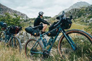 Image shows a rider sitting by the Ribble Gravel 725 gravel bike