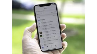 Dropbox on iPhone X while the phone is being held in someone's hand.