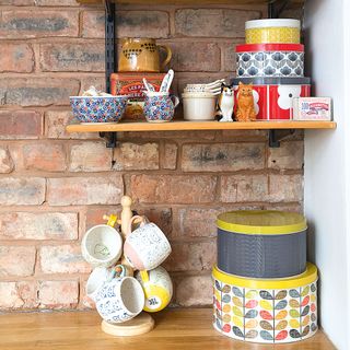 Kitchen corner with brick wall and open shelve