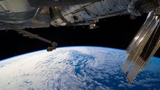A view of Earth from the International Space Station, with a solar panel seen in the top right corner