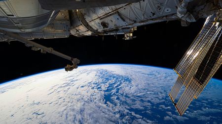 A view of Earth from the International Space Station, with a solar panel seen in the top right corner