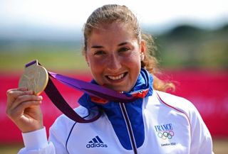 Mountain biker Julie Bresset (France) on the podium with her Olympic gold medal.