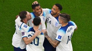 Marcus Rashford is congratulated by his team-mates after scoring for England against Wales in the World Cup.