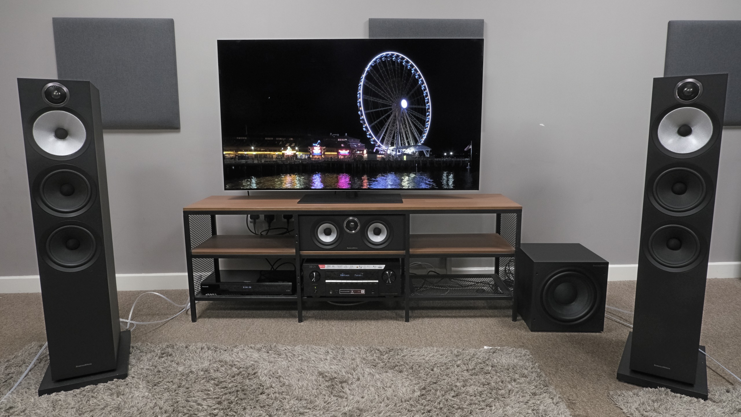 Denon receiver and B&amp;W speakers connected to LG G6 with picture of ferris wheel at night on screen 