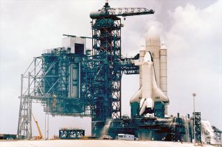 The external tank ground vibration test article (ET-GTVA), mounted with two solid rocket boosters and the prototype orbiter Enteprise, stands on Pad 39A at NASA's Kennedy Space Center in Florida on Feb. 6, 1980 for a fit check of the launch facilities.