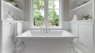 White bathroom with centre bathtub