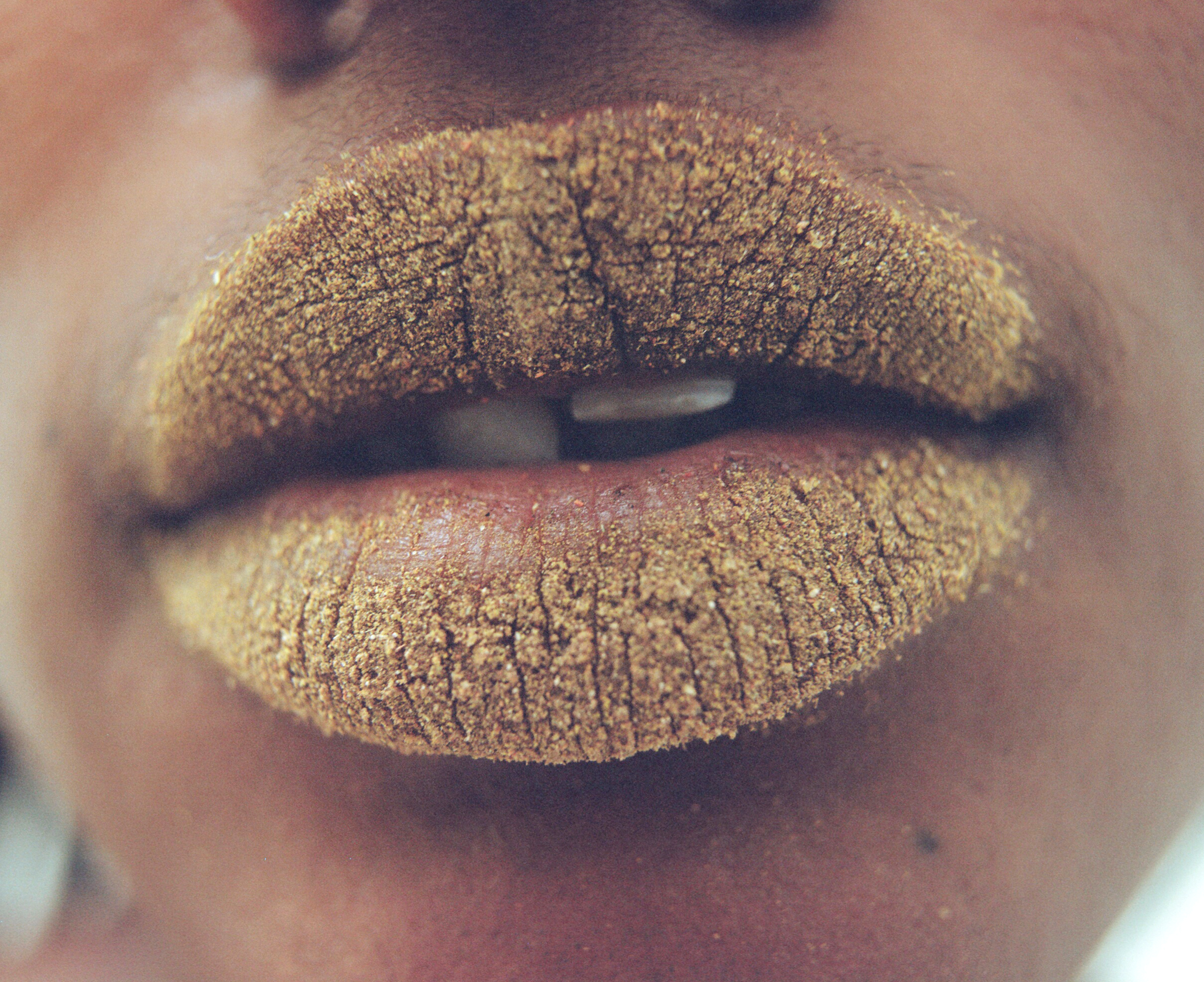 NeoNutritions campaign image; lips covered in sand