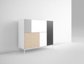 A multi-compartment cabinet in bright natural colours - white, light wood brown, green, grey.