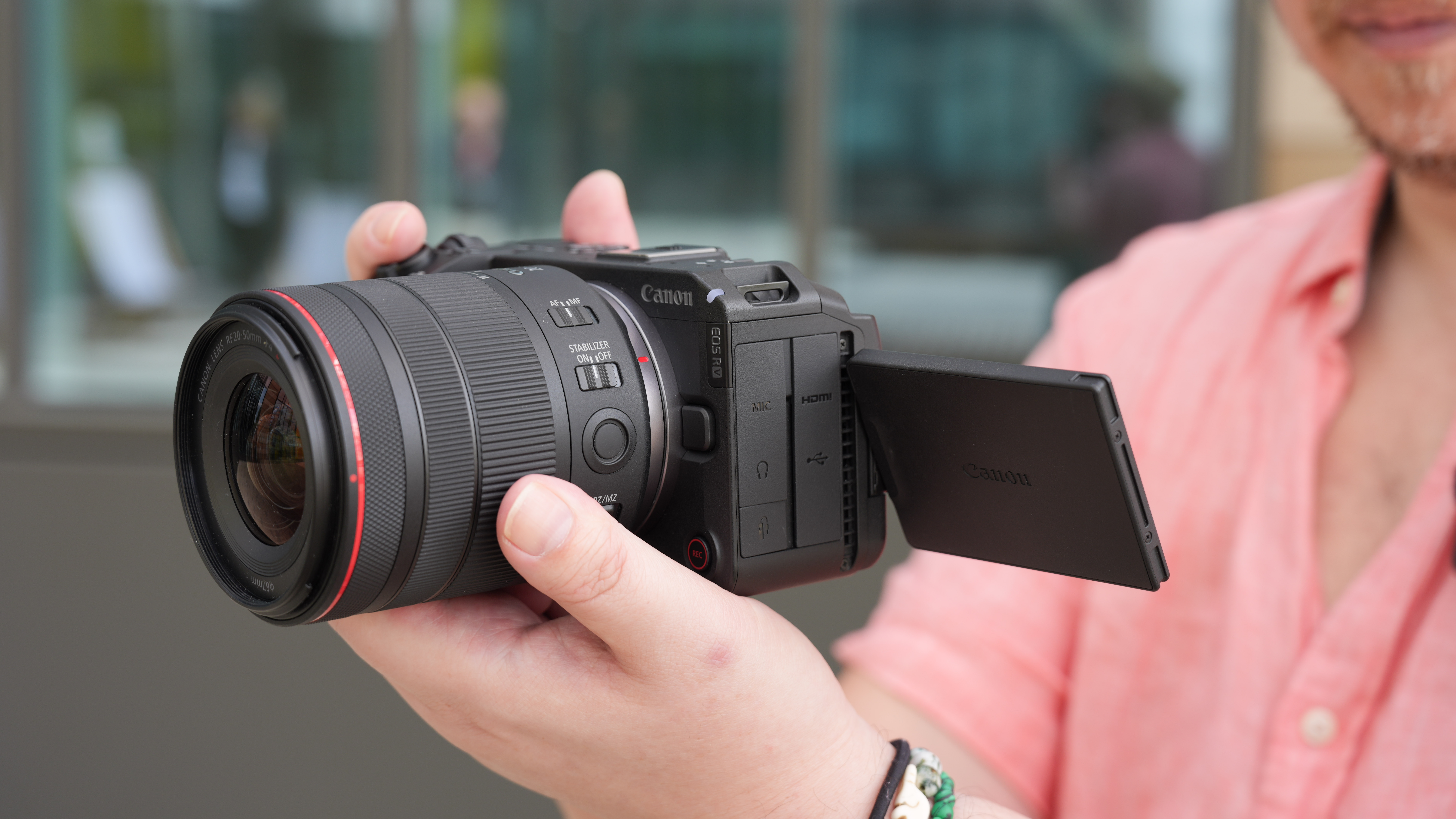 Canon EOS R6 V with the Canon RF 20-50mm f/4L IS USM PZ being held by a videographer