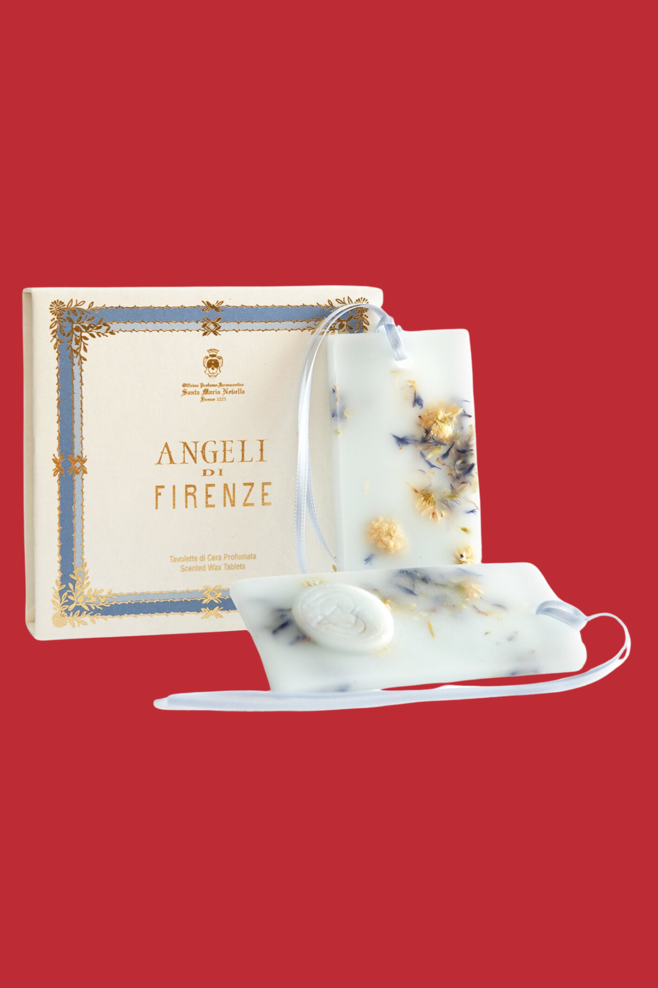 A pair of light blue potpourri wax tablets by a box