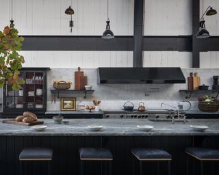 A kitchen with a large grey soapstone island