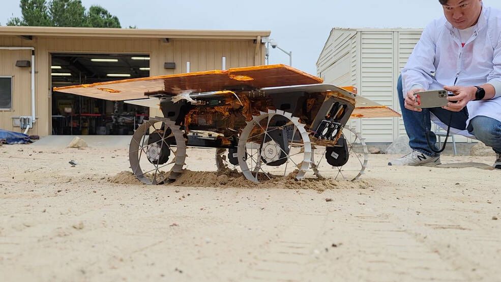 a small four-wheeled rover travels across sand in a test yard at nasa&#039;s jet propulsion laboratory.