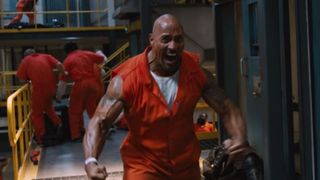 Dwayne Johnson flexes his muscles in a prison riot in The Fate of the Furious
