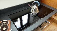 induction hob with kettle on to support a guide on what you need to know before buying an induction hob