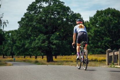 Female cyclist riding on the hoods