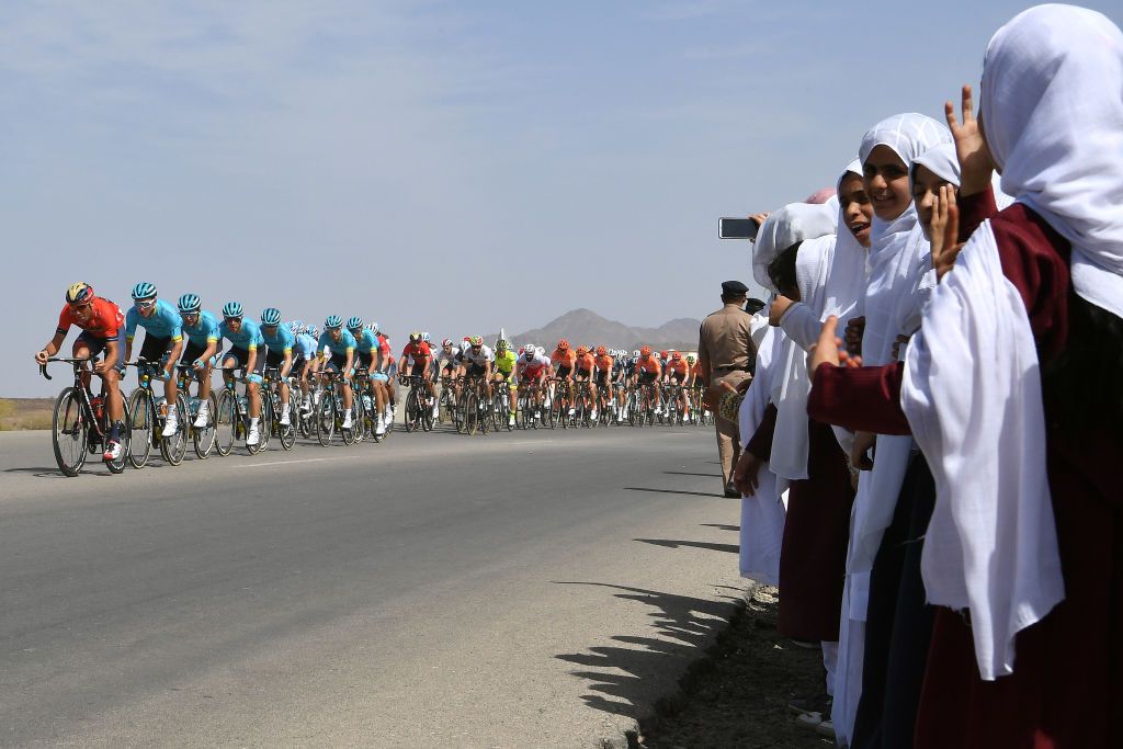 Locals watch the peloton go by