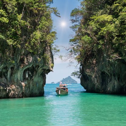 jk29wf beautiful landscape of rocks mountain and crystal clear sea with longtail boat at phuket, thailand summer, travel, vacation, holiday concept