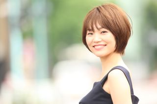 A woman with a bob hairstyle smiling at the camera